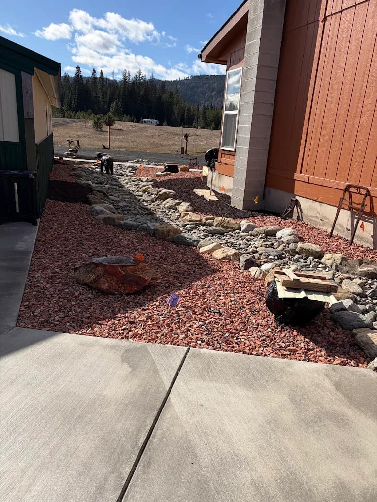 Decorative rock landscaping and dry creek bed beside a home